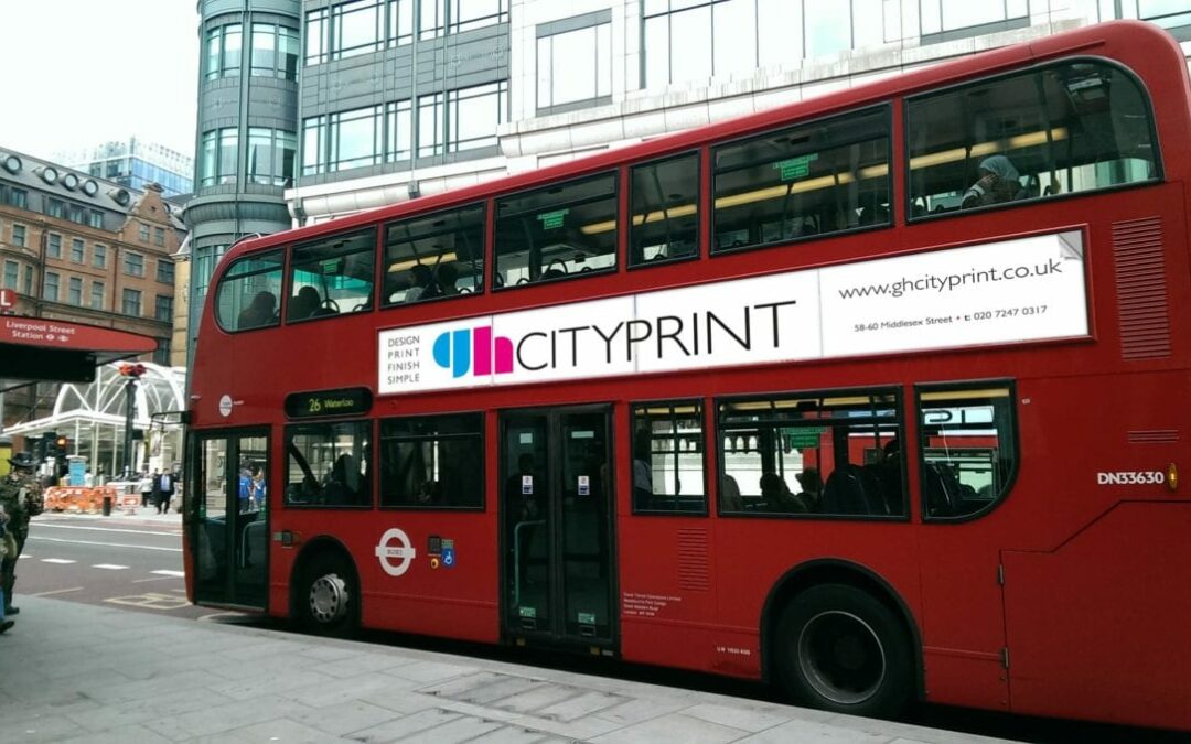 red city bus wih printed ad on the side